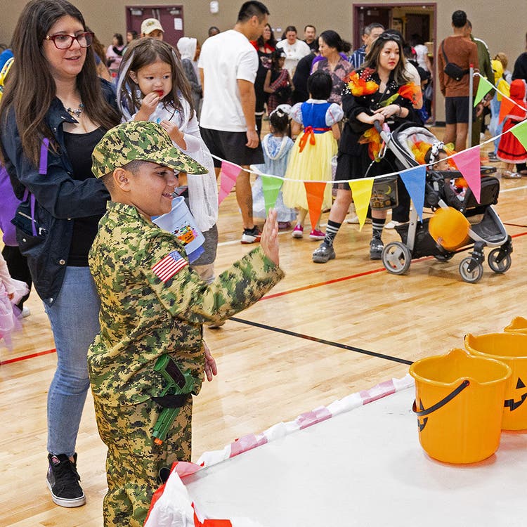 Child in costume at festive indoor event