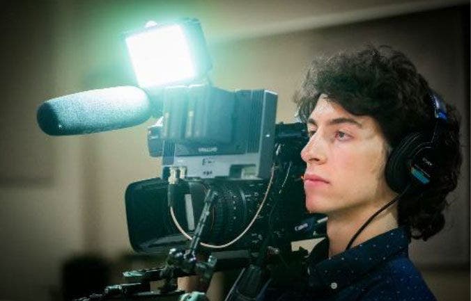 Professional videographer with camera setup